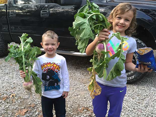 Children with plants from SOO food plot